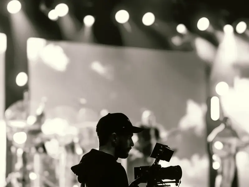 Videographer filming a live concert performance