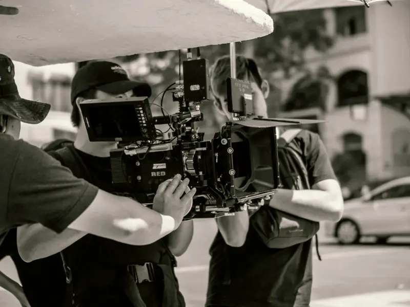 Camera crew operating a cinema camera on location for a documentary shoot