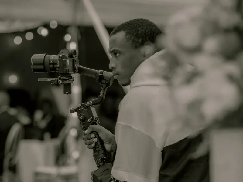 Videographer filming an evening event
