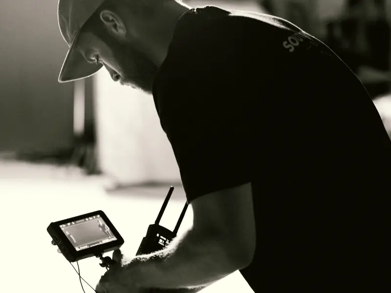 Operator checking a wireless monitor during a studio shoot