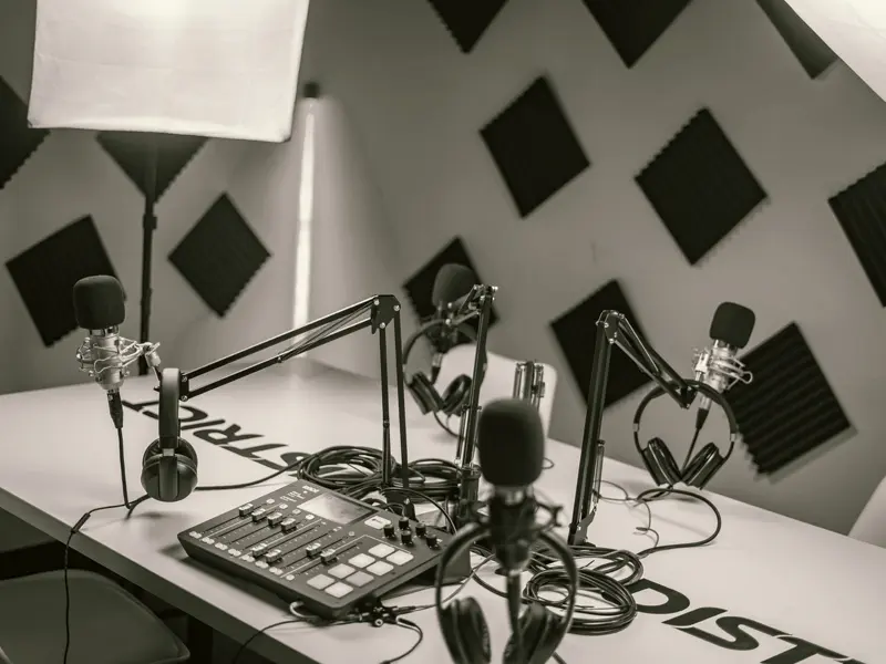 Multi-microphone podcast studio lit for a filmed episode