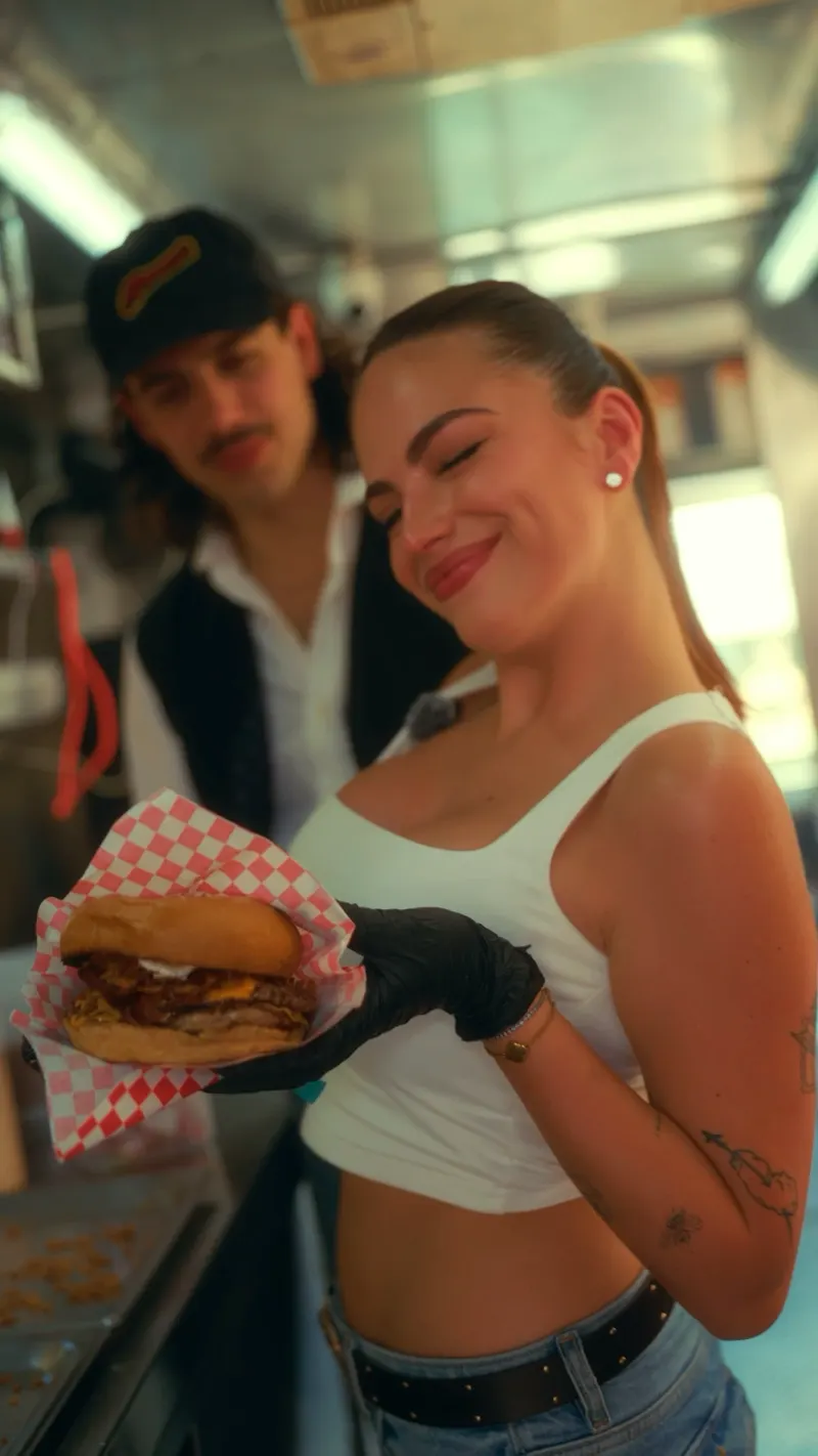 Behind the counter at a burger spot, filmed for social